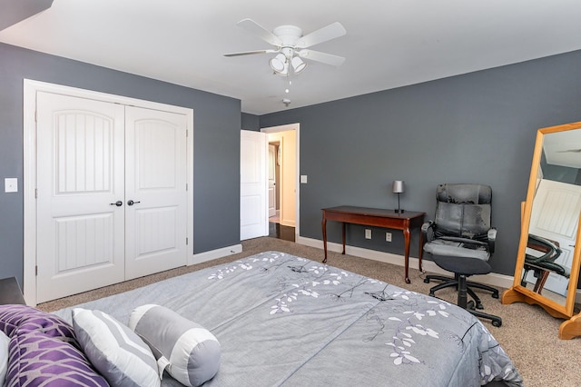 carpeted bedroom featuring baseboards, a closet, and a ceiling fan