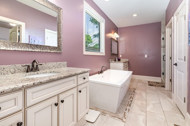 bathroom with two vanities, marble look tile flooring, a shower stall, a freestanding tub, and recessed lighting