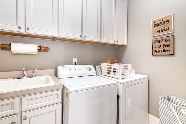 washroom featuring washer and dryer and cabinet space