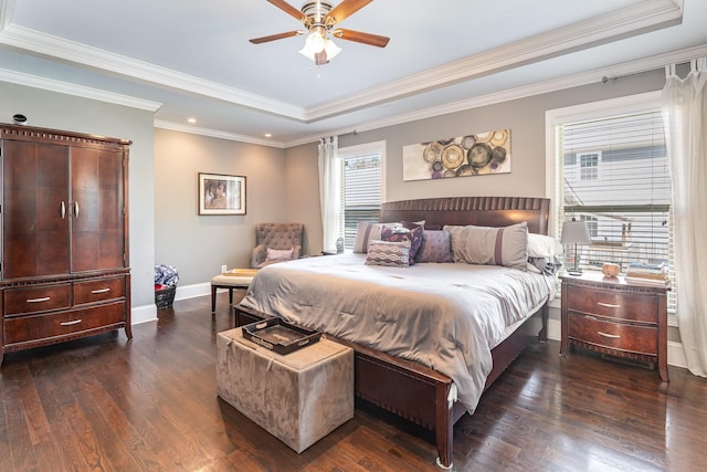 bedroom featuring a tray ceiling, dark wood-style floors, recessed lighting, ornamental molding, and baseboards