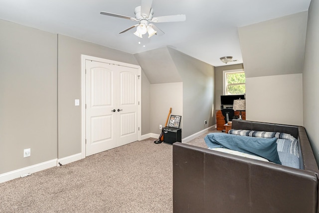 bedroom featuring carpet flooring, lofted ceiling, a desk, baseboards, and ceiling fan