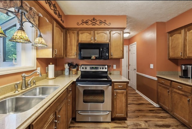 421 Robertson Dr, Smyrna, TN 37167 - kitchen featuring black microwave, stainless steel range with electric stovetop, a sink, dark wood finished floors, and light countertops