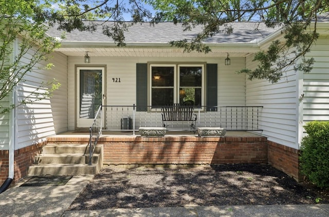421 Robertson Dr, Smyrna, TN 37167 - view of exterior entry featuring a porch and roof with shingles