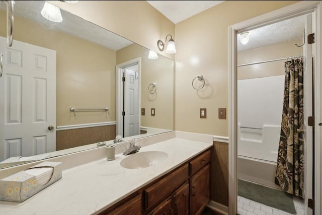 421 Robertson Dr, Smyrna, TN 37167 - full bathroom with vanity, a wainscoted wall, and shower / tub combo
