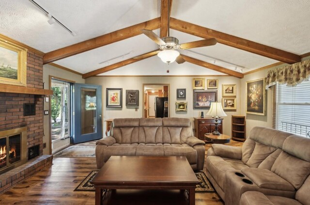 421 Robertson Dr, Smyrna, TN 37167 - living area featuring wood finished floors, track lighting, a fireplace, and ceiling fan