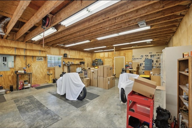421 Robertson Dr, Smyrna, TN 37167 - garage with a workshop area, wooden walls, and electric panel