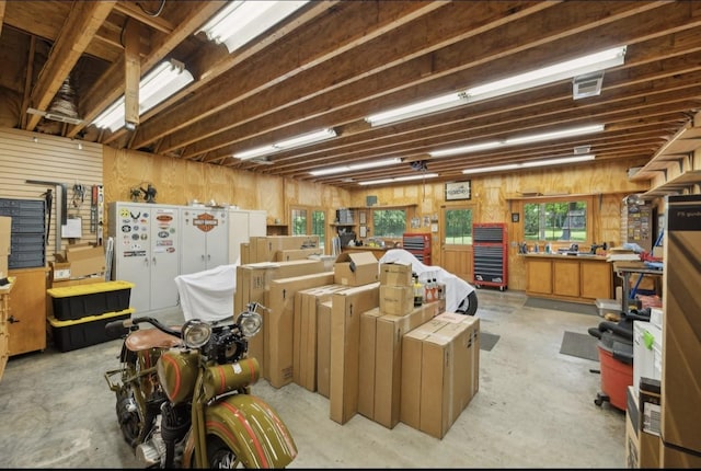 421 Robertson Dr, Smyrna, TN 37167 - misc room with concrete flooring, plenty of natural light, a workshop area, and wooden walls