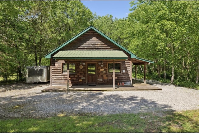 421 Robertson Dr, Smyrna, TN 37167 - view of front of property with a porch, metal roof, and a view of trees