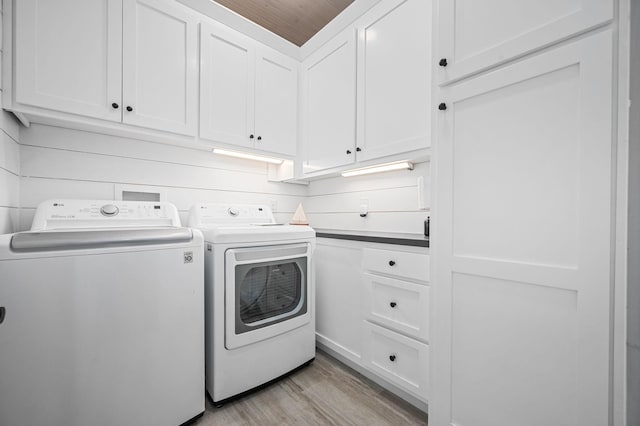 61 Sunset Ct, Tracy City, TN 37387 - laundry area featuring independent washer and dryer, cabinet space, and light wood-style floors