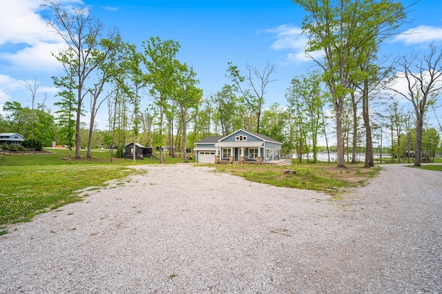 61 Sunset Ct, Tracy City, TN 37387 - view of front facade with driveway, covered porch, a garage, and a front lawn