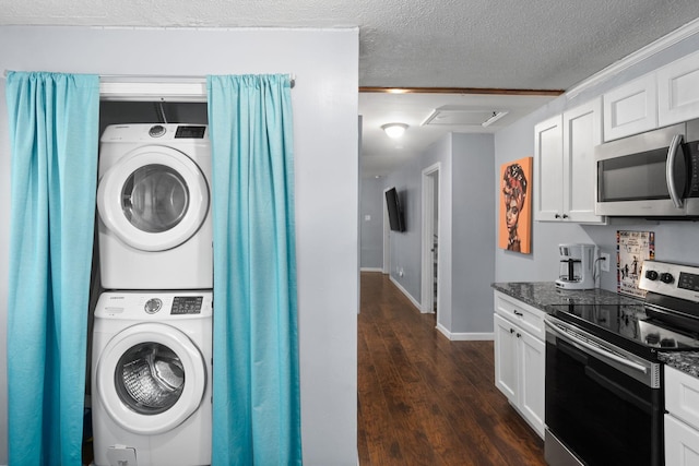 washroom with stacked washer and clothes dryer, baseboards, dark wood-style flooring, and a textured ceiling