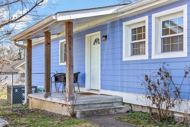 property entrance with fence and central AC unit