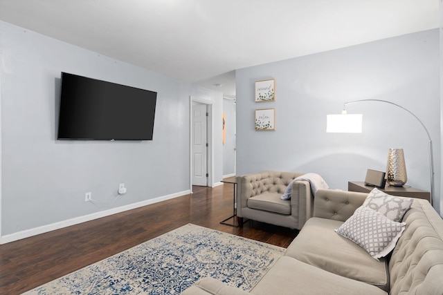 living area with wood finished floors and baseboards