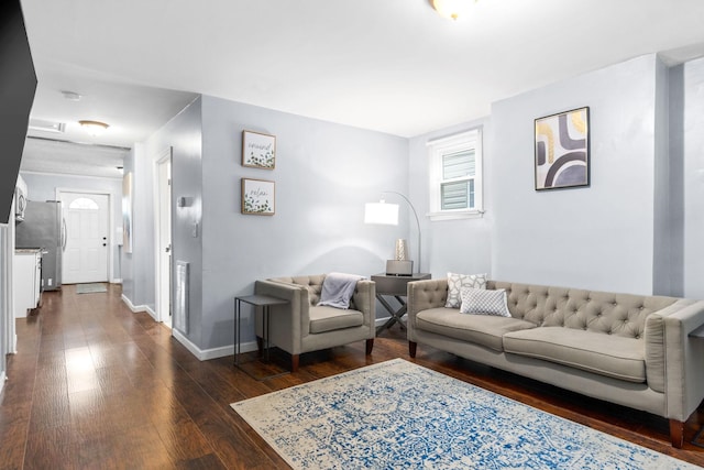 living room featuring baseboards, dark wood-style flooring, and healthy amount of natural light