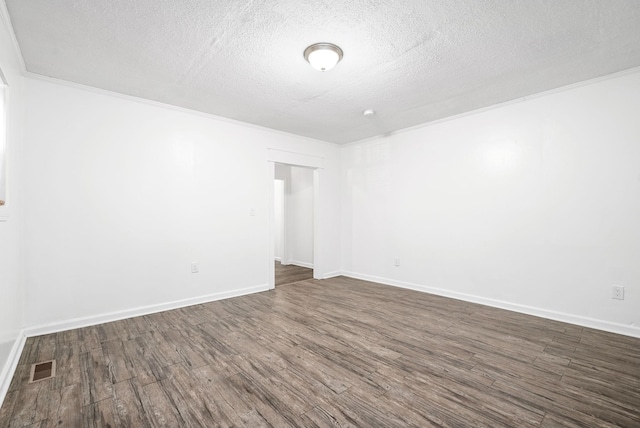 unfurnished room with dark wood finished floors, a textured ceiling, and baseboards