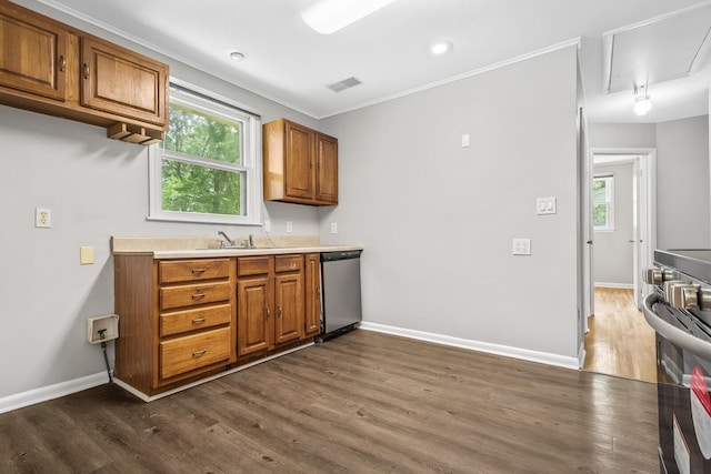 1003 Copper Still Cir, Kingston Springs, TN 37082 - kitchen featuring appliances with stainless steel finishes, brown cabinets, baseboards, dark wood-style flooring, and crown molding