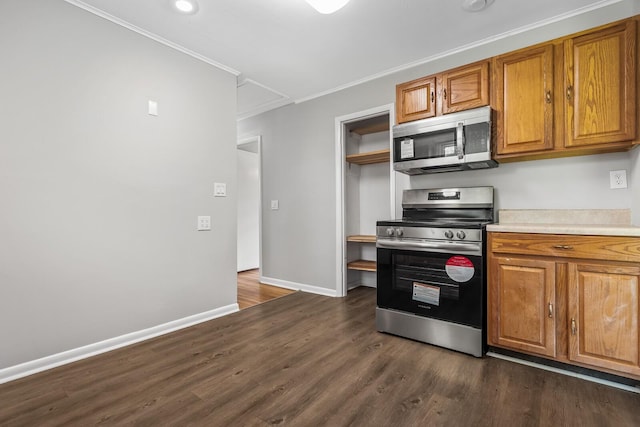1003 Copper Still Cir, Kingston Springs, TN 37082 - kitchen with stainless steel appliances, ornamental molding, brown cabinets, baseboards, and dark wood-type flooring