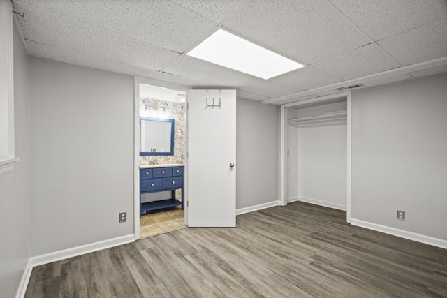 553 Huntington Pkwy, Nashville, TN 37211 - unfurnished bedroom featuring wood finished floors, a paneled ceiling, baseboards, connected bathroom, and a closet