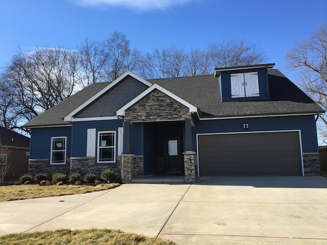 craftsman-style home featuring stone siding, concrete driveway, a shingled roof, and a garage