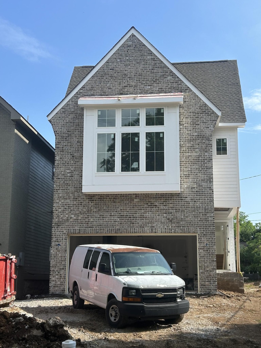 6304 Henry Ford Dr Unit B, Nashville, TN 37209 - view of front of home featuring an attached garage, brick siding, a shingled roof, and driveway