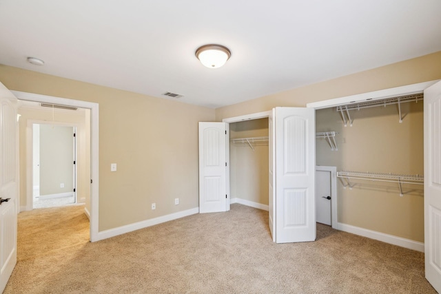1015 Kingman Ave, Murfreesboro, TN 37129 - unfurnished bedroom with multiple closets, light colored carpet, and baseboards