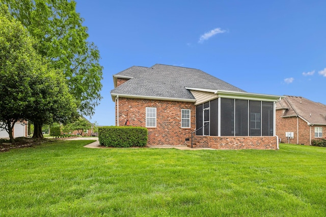 1015 Kingman Ave, Murfreesboro, TN 37129 - rear view of house featuring a sunroom, brick siding, a shingled roof, and a lawn