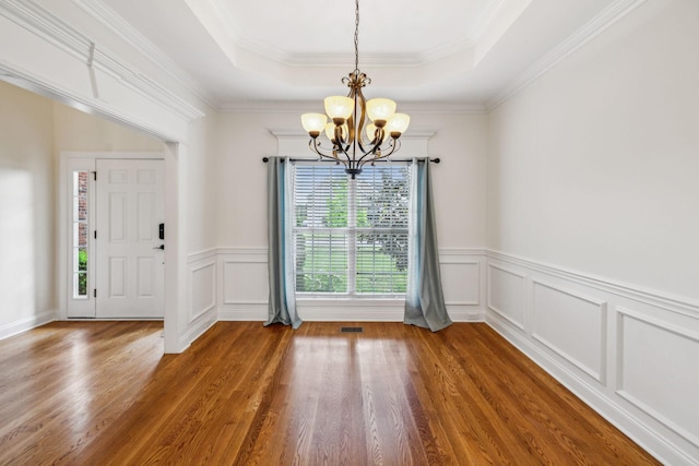 1015 Kingman Ave, Murfreesboro, TN 37129 - unfurnished dining area featuring a chandelier, wood finished floors, a tray ceiling, wainscoting, and a decorative wall