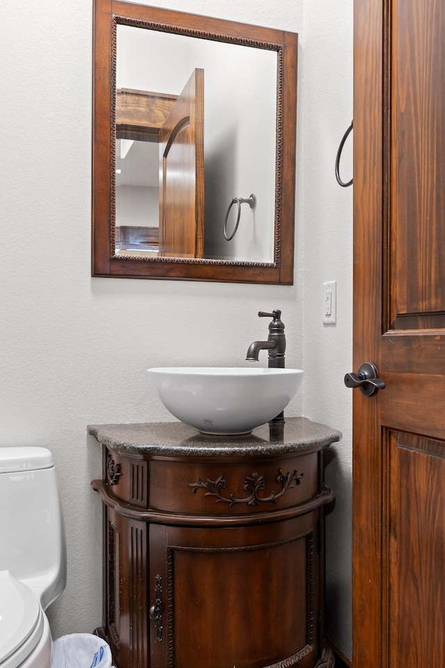 half bath with vanity and toilet