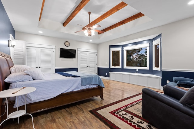 bedroom featuring recessed lighting, wood finished floors, a tray ceiling, beam ceiling, and ceiling fan