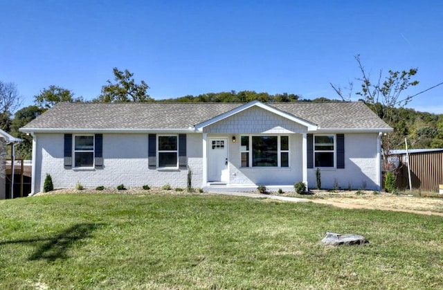 ranch-style home with a front lawn and brick siding