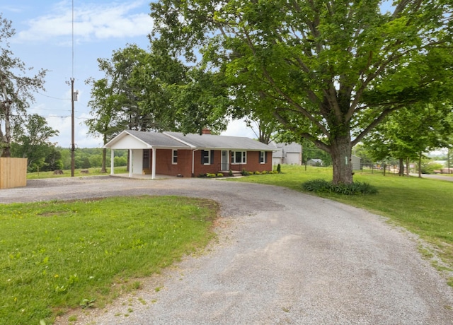 2851 Cooper Creek Rd, Woodlawn, TN 37191 - single story home with curved driveway, a front lawn, a chimney, and a carport