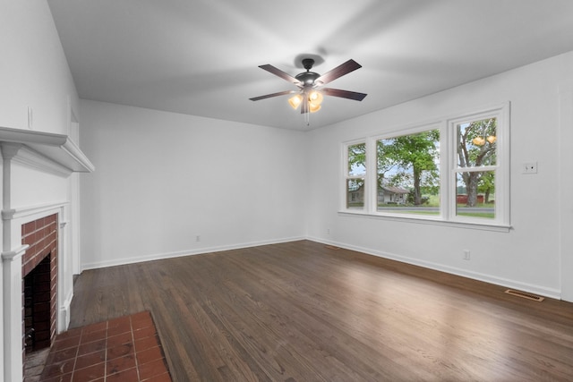 2851 Cooper Creek Rd, Woodlawn, TN 37191 - unfurnished living room featuring a ceiling fan, dark wood-style flooring, a brick fireplace, and baseboards