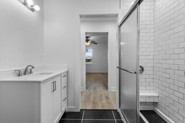 2851 Cooper Creek Rd, Woodlawn, TN 37191 - bathroom featuring a shower with door, a ceiling fan, tile patterned floors, vanity, and baseboards