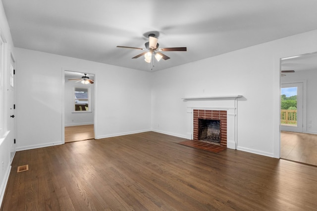 2851 Cooper Creek Rd, Woodlawn, TN 37191 - unfurnished living room with ceiling fan, a brick fireplace, wood finished floors, and baseboards