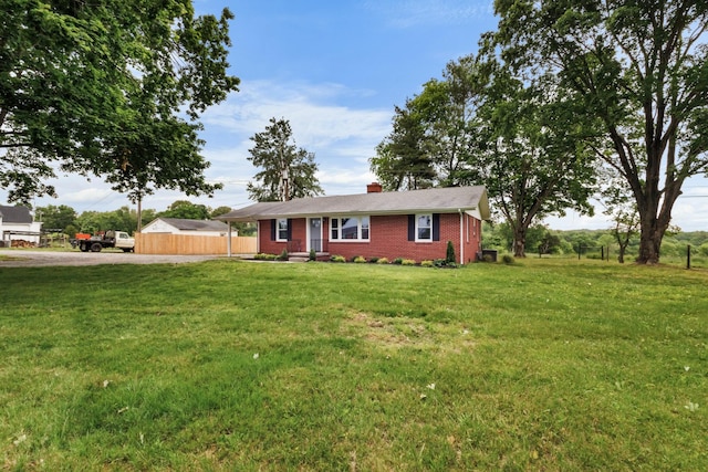 2851 Cooper Creek Rd, Woodlawn, TN 37191 - single story home with dirt driveway, a chimney, a front yard, and brick siding