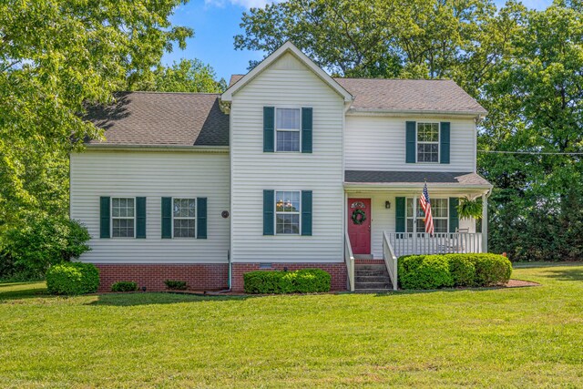 7104 Elrod Rd, Fairview, TN 37062 - traditional home featuring a porch, a front lawn, and a chimney