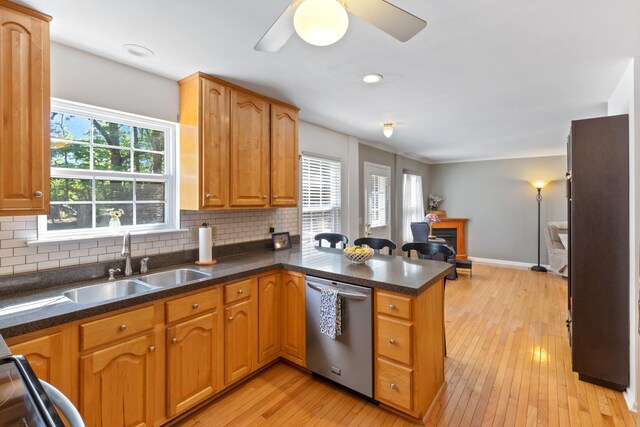 7104 Elrod Rd, Fairview, TN 37062 - kitchen featuring dishwasher, a peninsula, a sink, light wood finished floors, and backsplash
