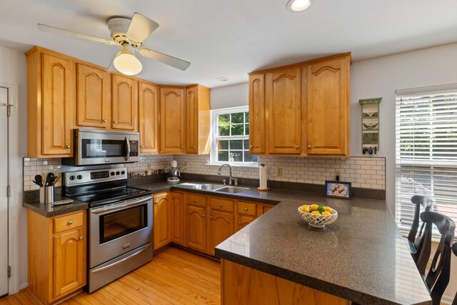 7104 Elrod Rd, Fairview, TN 37062 - kitchen featuring appliances with stainless steel finishes, a peninsula, a sink, backsplash, and recessed lighting