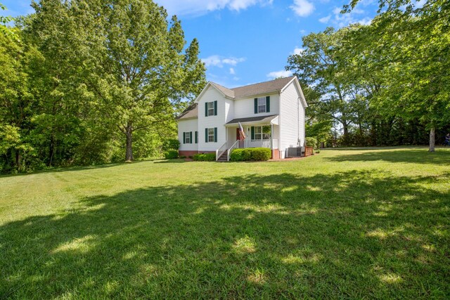 7104 Elrod Rd, Fairview, TN 37062 - traditional home featuring a front lawn, a porch, and central AC unit