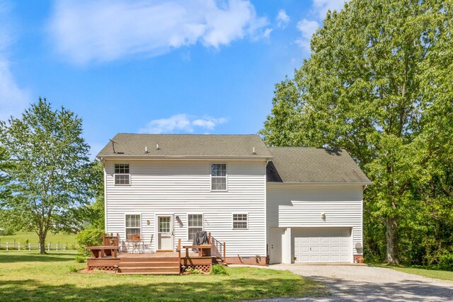 7104 Elrod Rd, Fairview, TN 37062 - rear view of house featuring gravel driveway, a wooden deck, a lawn, an attached garage, and roof with shingles