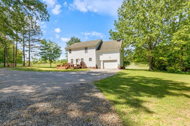7104 Elrod Rd, Fairview, TN 37062 - view of front of home featuring driveway, a wooden deck, a front lawn, and a garage
