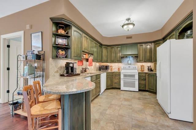1764 Warren Hollow Rd, Nolensville, TN 37135 - kitchen featuring green cabinetry, white appliances, a peninsula, open shelves, and a sink
