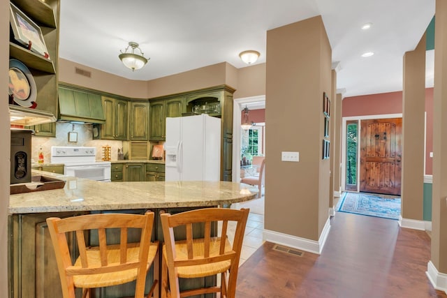 1764 Warren Hollow Rd, Nolensville, TN 37135 - kitchen with green cabinets, white appliances, a peninsula, custom exhaust hood, and decorative backsplash