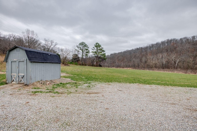 8310 Dog Creek Rd, Primm Springs, TN 38476 - view of green lawn with a storage unit, an outdoor structure, and a view of trees