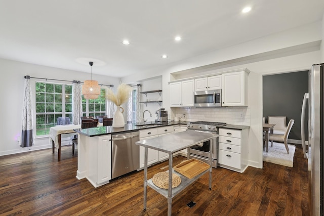 1423 Clairmonte Cir, Franklin, TN 37064 - kitchen featuring appliances with stainless steel finishes, a sink, a peninsula, dark countertops, and recessed lighting