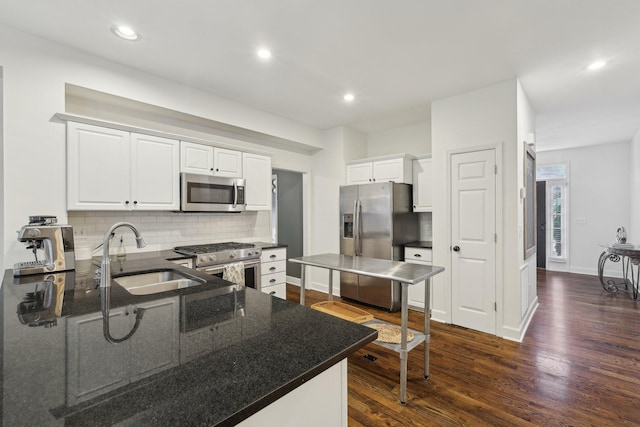1423 Clairmonte Cir, Franklin, TN 37064 - kitchen featuring appliances with stainless steel finishes, a sink, tasteful backsplash, dark wood finished floors, and recessed lighting