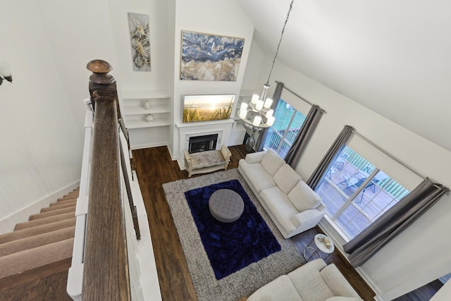 1423 Clairmonte Cir, Franklin, TN 37064 - living area with a fireplace, wood finished floors, built in features, stairs, and a chandelier