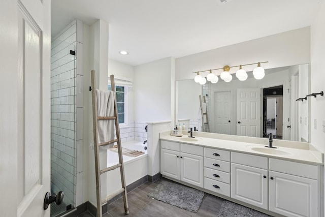 1423 Clairmonte Cir, Franklin, TN 37064 - full bathroom featuring a garden tub, double vanity, tiled shower, wood finished floors, and recessed lighting