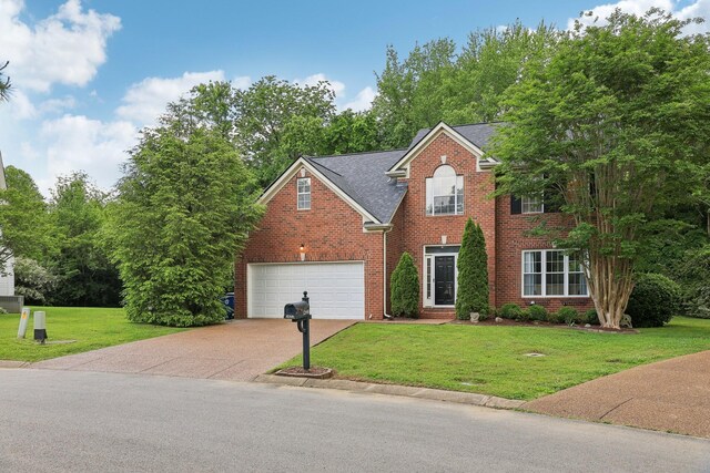 1423 Clairmonte Cir, Franklin, TN 37064 - view of front facade with brick siding, concrete driveway, a garage, a front yard, and a shingled roof