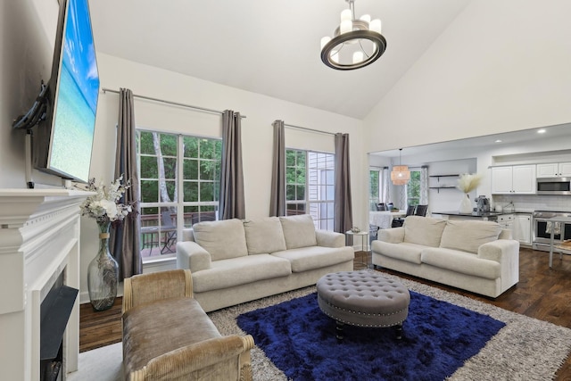 1423 Clairmonte Cir, Franklin, TN 37064 - living area with dark wood-style floors, a chandelier, high vaulted ceiling, and a fireplace